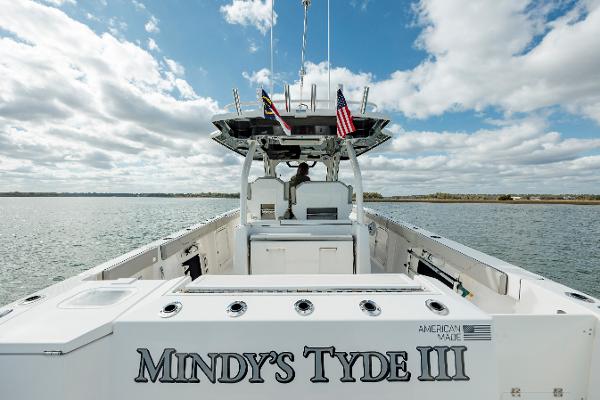 Slide: The Image of 2022 Pursuit S 328 boat named Mindy's Tyde III on open water under a cloudy sky. - 25