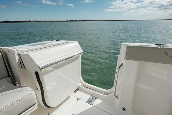 Slide: The Image of 2022 Pursuit S 328 boat with open side door on calm water. - 31