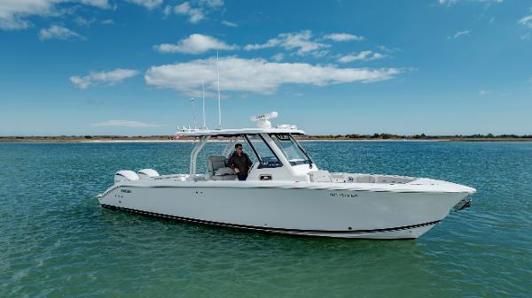 Slide: The Image of 2022 Pursuit S 328 boat on calm water with clear blue sky. - 4