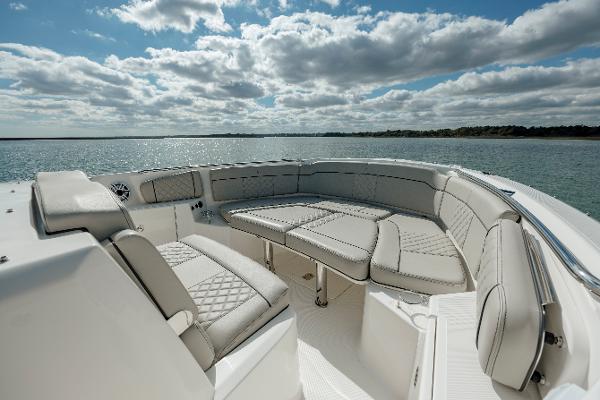 Slide: The Image of 2022 Pursuit S 328 boat with luxurious seating on a sunny day. - 45