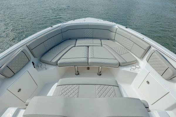 Slide: The Image of 2022 Pursuit S 328 boat with luxurious seating and ocean backdrop. - 46