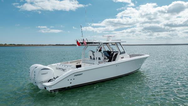 Slide: The Image of 2022 Pursuit S 328 boat on calm water under a partly cloudy sky. - 6