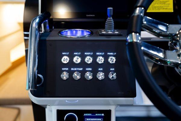 Slide: The Image of Control panel of the 2024 Quarken 27 T-Top V2 boat with illuminated switches. - 17