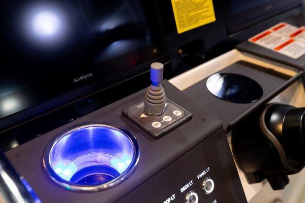 Slide: The Image of Control panel of the 2024 Quarken 27 T-Top V2 boat with joystick and illuminated cup holder. - 18