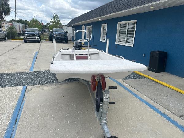 Slide: The Image of 2023 Rabco Buccaneer 14 skiff on trailer, parked outside a blue building. - 3