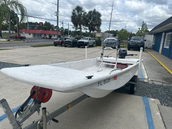 Slide: The Image of 2023 Rabco Buccaneer 14 skiff on trailer in parking lot. - 5