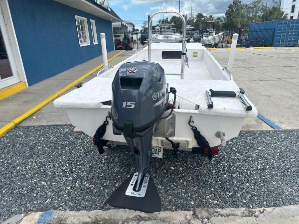 Slide: The Image of 2023 Rabco Buccaneer 14 skiff with Yamaha 15 outboard motor, parked on gravel. - 7
