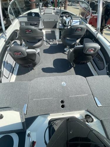 Slide: The Image of 2023 Ranger 1850MS boat interior with seating and steering console. - 2