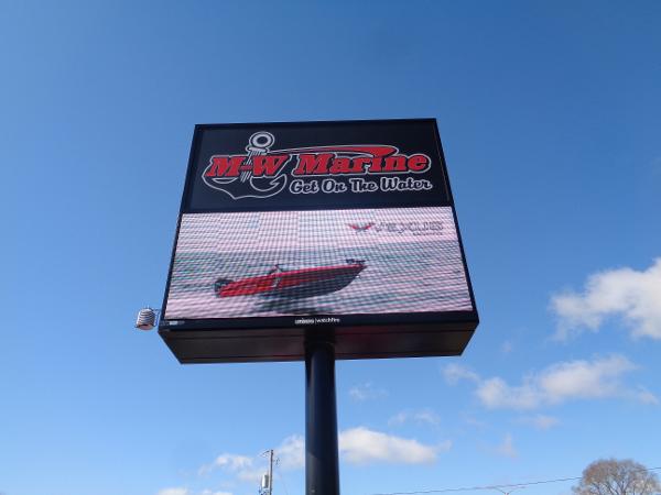 Slide: The Image of MW Marine sign advertising 2024 Ranger 1850 Reata boat against blue sky. - 17