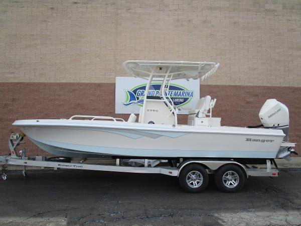 Slide: The Image of 2024 Ranger 2360 Bay boat on a trailer at a marina. - 1