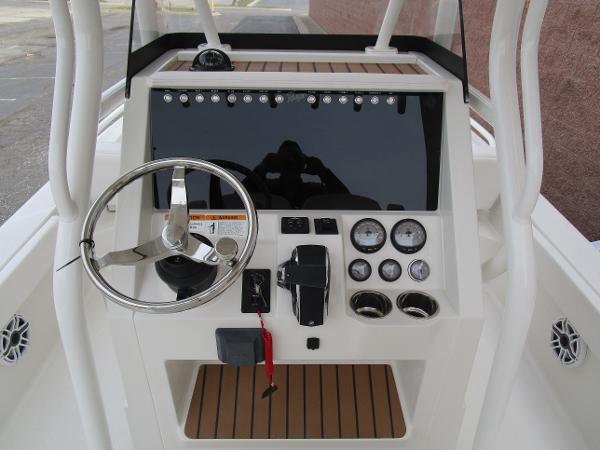 Slide: The Image of 2024 Ranger 2360 Bay boat console with steering wheel, gauges, and controls. - 20