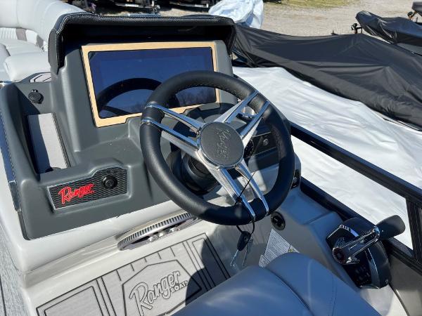 Slide: The Image of 2023 Ranger 2500LS boat dashboard with steering wheel and control panel. - 4