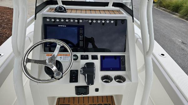 Slide: The Image of 2024 Ranger 2600 Bay boat console with steering wheel and navigation screens. - 20