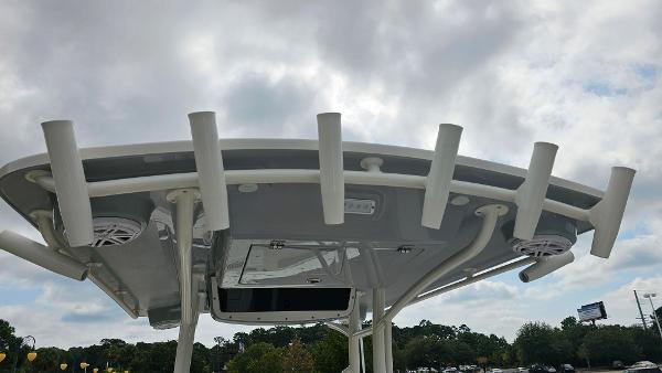 Slide: The Image of 2024 Ranger 2600 Bay boat T-top with rod holders and speakers. - 24