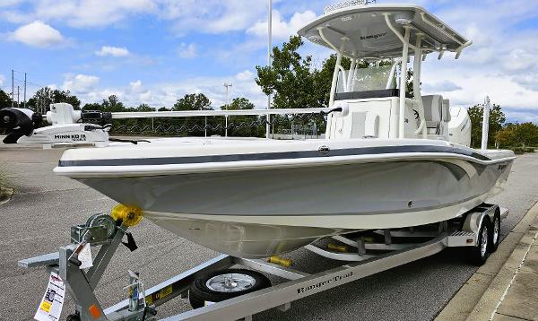 Slide: The Image of 2024 Ranger 2600 Bay boat on a trailer in a parking lot. - 7