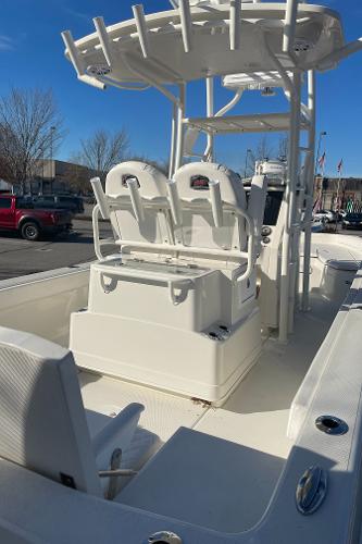Slide: The Image of 2024 Ranger 2660 Bay boat with dual seating and T-top in a parking lot. - 3