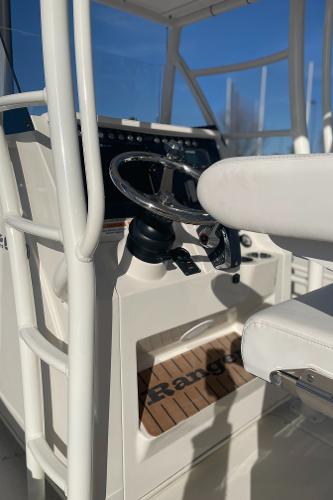 Slide: The Image of 2024 Ranger 2660 Bay boat helm with steering wheel and controls. - 7