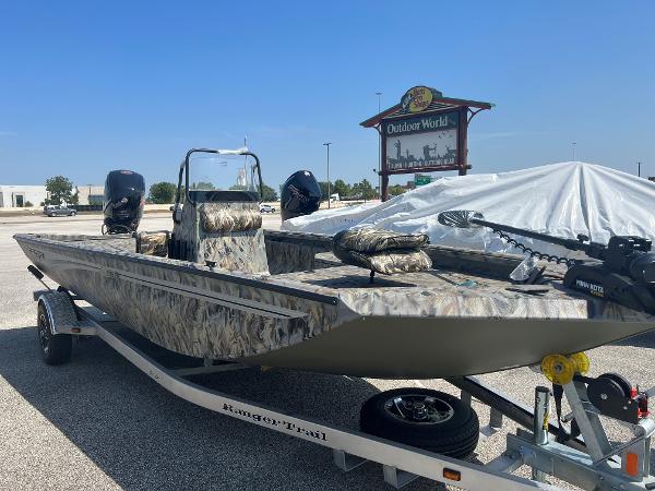 Slide: The Image of 2024 Ranger RB190 boat in camouflage pattern on a trailer at Outdoor World. - 0