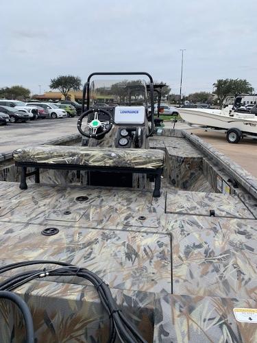 Slide: The Image of 2024 Ranger RB190 boat with camo design, featuring a Lowrance system, parked in a lot. - 2