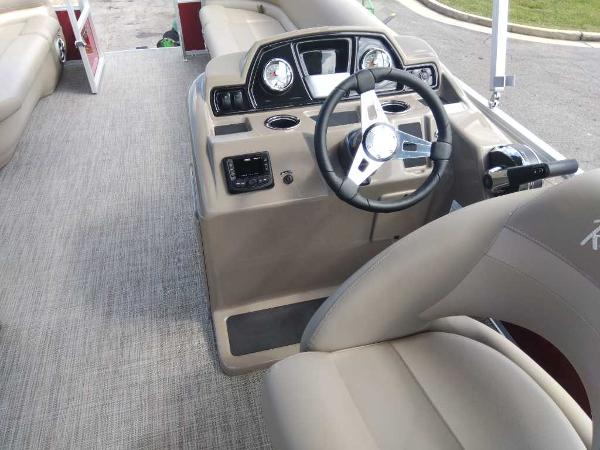 Slide: The Image of 2024 Ranger Reata 200C boat interior with steering console and seating. - 16