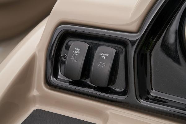 Slide: The Image of 2024 Ranger Reata 200C boat control panel with navigation and court lights switches. - 38