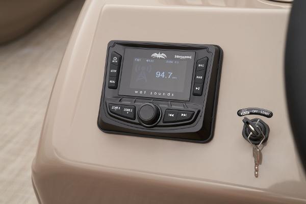 Slide: The Image of 2024 Ranger Reata 200C boat dashboard with stereo system and ignition key. - 39