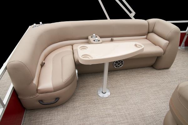 Slide: The Image of 2024 Ranger Reata 200C boat interior with beige seating and table. - 44
