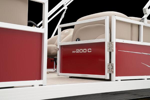 Slide: The Image of 2024 Ranger Reata 200C pontoon boat with red paneling and beige seating. - 49