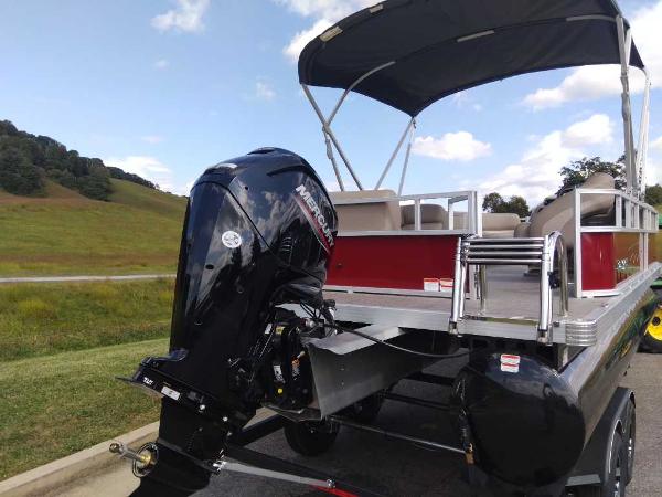 Slide: The Image of 2024 Ranger Reata 200C pontoon boat with Mercury outboard motor on a trailer. - 5