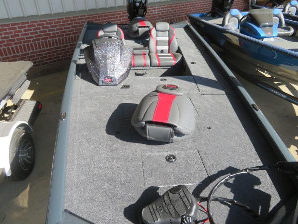 Slide: The Image of 2023 Ranger RT178C fishing boat with gray and red seating, docked beside another boat. - 5