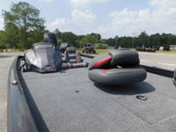 Slide: The Image of 2024 Ranger RT178C fishing boat with seating and motor, parked outdoors. - 5