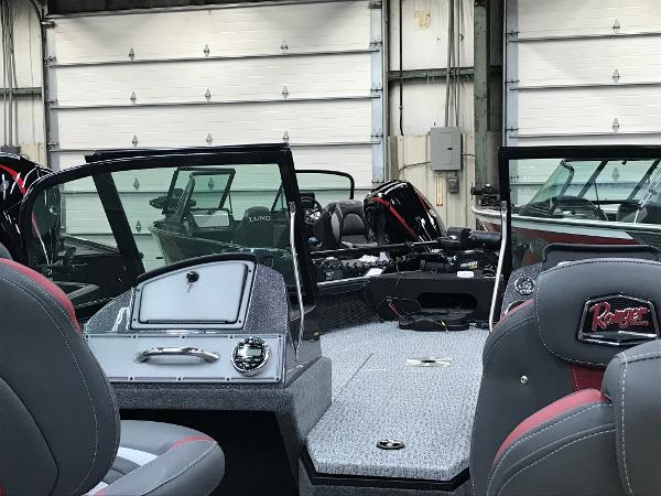 Slide: The Image of 2024 Ranger VS1782SC Angler boat interior with seating and dashboard in a garage. - 9