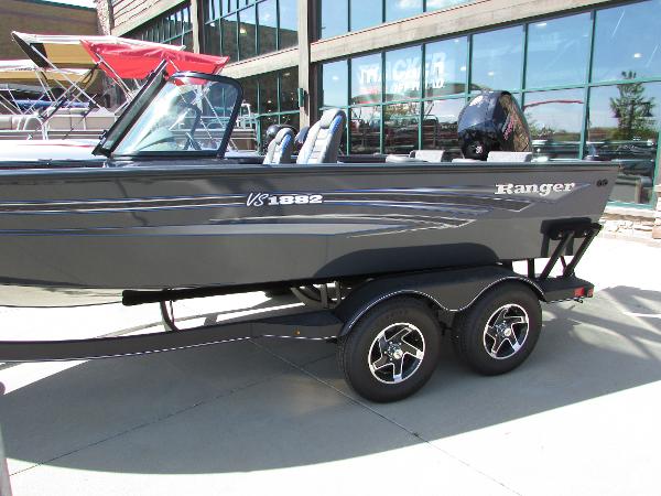 Slide: The Image of 2023 Ranger VS1882SC Angler boat on a trailer outside a showroom. - 1