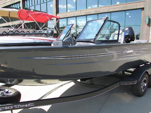 Slide: The Image of 2023 Ranger VS1882SC Angler boat on display outside a showroom. - 2