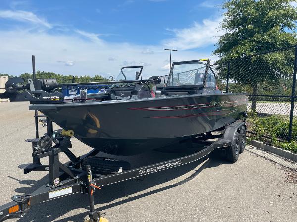 Slide: The Image of 2023 Ranger VX1788 WT fishing boat on a trailer in a parking lot. - 2