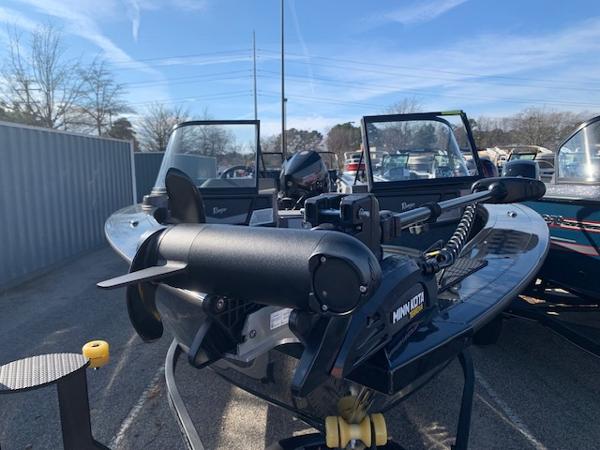 Slide: The Image of 2024 Ranger VX1888 WT boat with Minn Kota motor in a parking lot. - 1