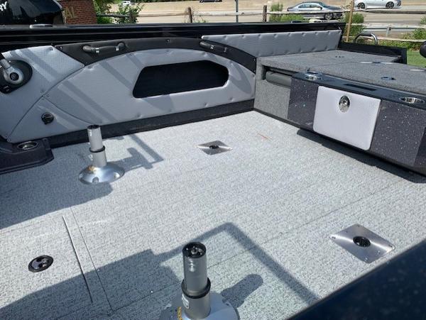 Slide: The Image of 2024 Ranger VX1888 WT boat interior with gray flooring and seating mounts. - 11