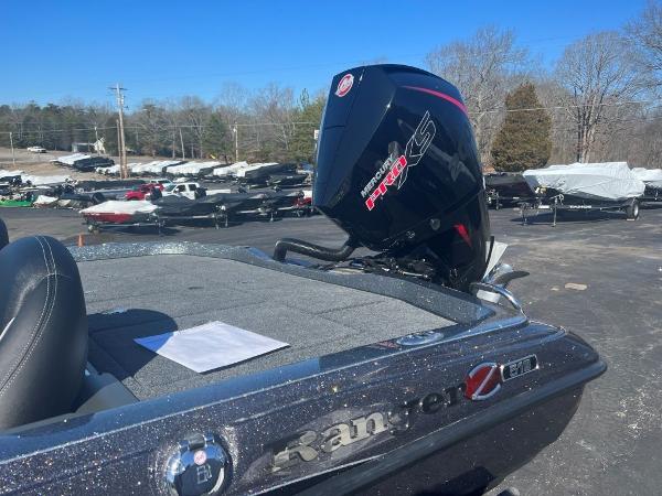 Slide: The Image of 2023 Ranger Z518 boat with Mercury Pro XS engine in a parking lot. - 2