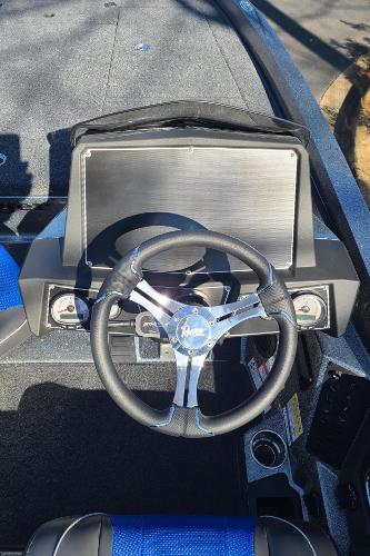 Slide: The Image of 2024 Ranger Z519 boat dashboard with steering wheel and control panel. - 11