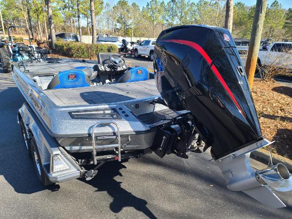 Slide: The Image of 2024 Ranger Z519 boat with powerful outboard motor, parked outdoors. - 6