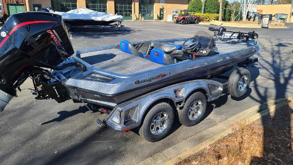 Slide: The Image of 2024 Ranger Z519 boat with triple-axle trailer in a parking lot. - 9