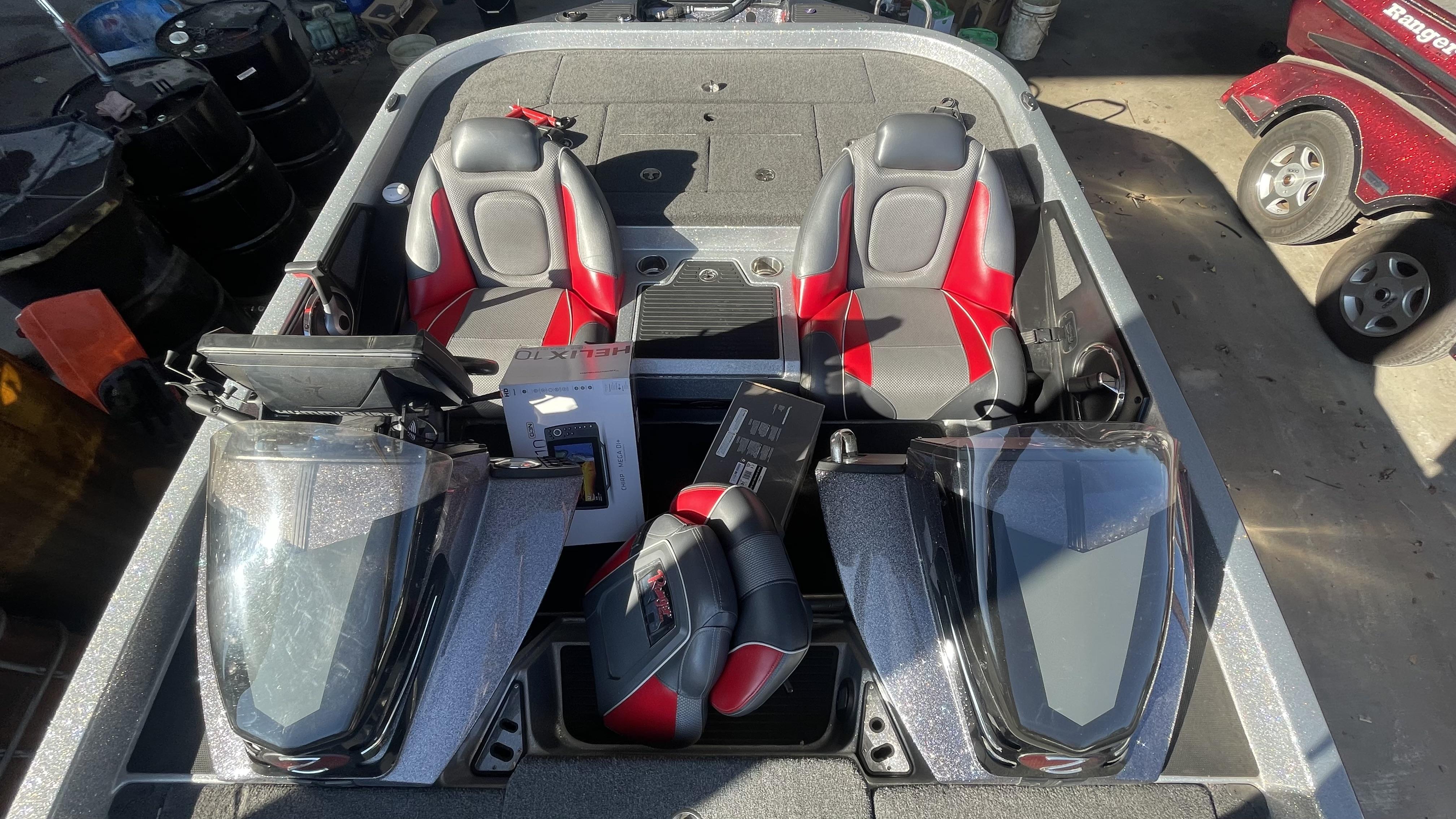 Slide: The Image of 2018 Ranger Z519C boat interior with dual seats and electronic equipment. - 13