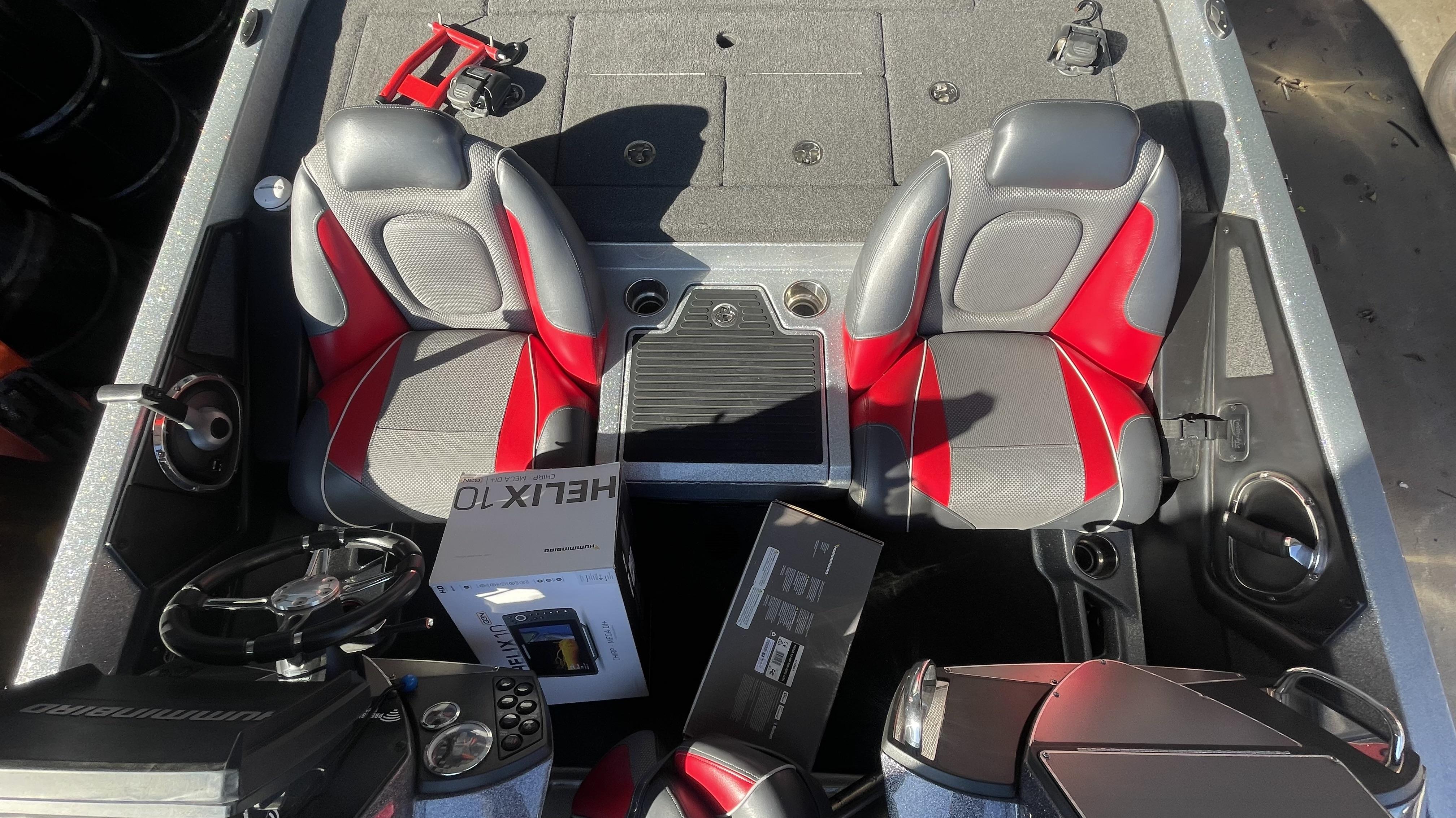 Slide: The Image of 2018 Ranger Z519C boat interior with red and gray seats, steering wheel, and electronics. - 14