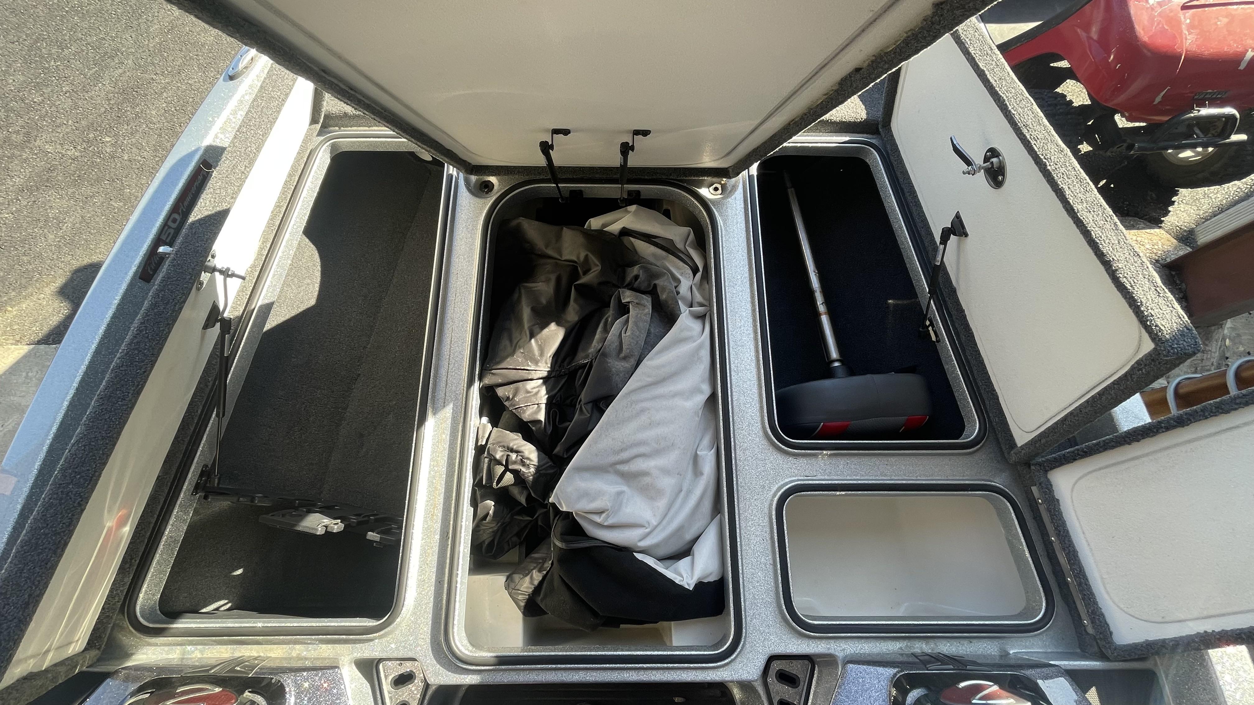 Slide: The Image of 2018 Ranger Z519C storage compartments with open lids, showing interior space and equipment. - 15