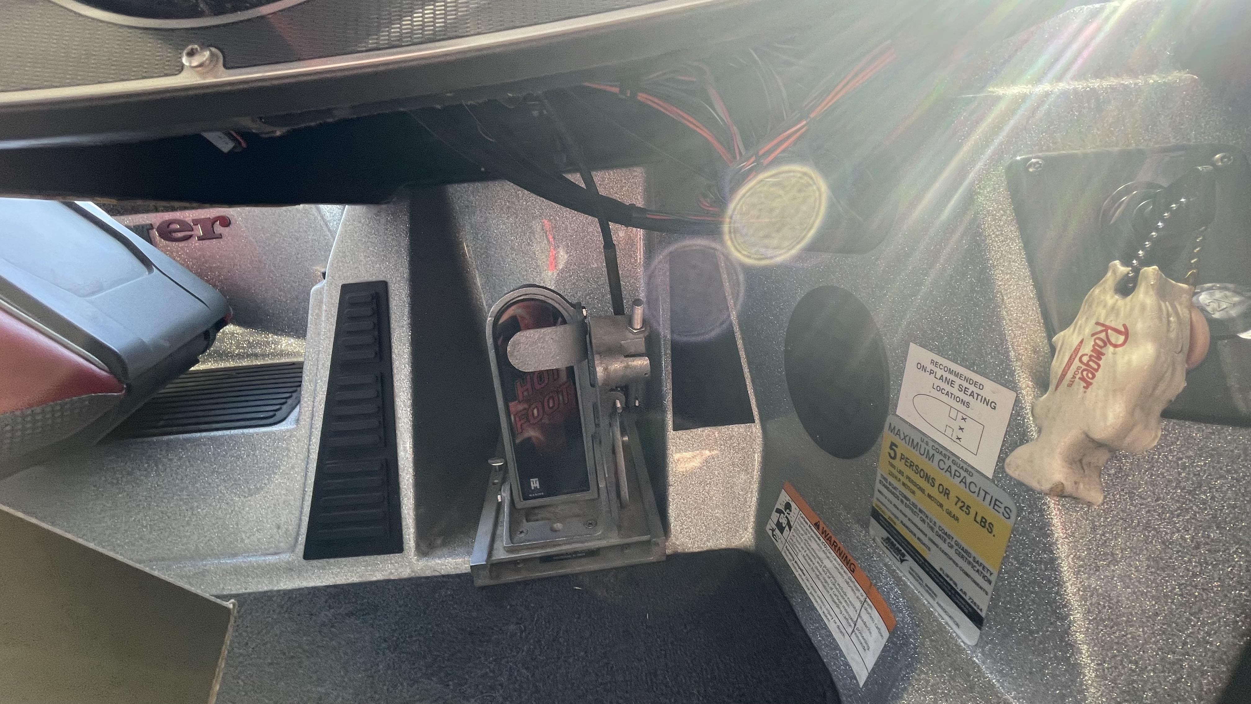 Slide: The Image of 2018 Ranger Z519C boat interior with foot throttle and safety warnings. - 21