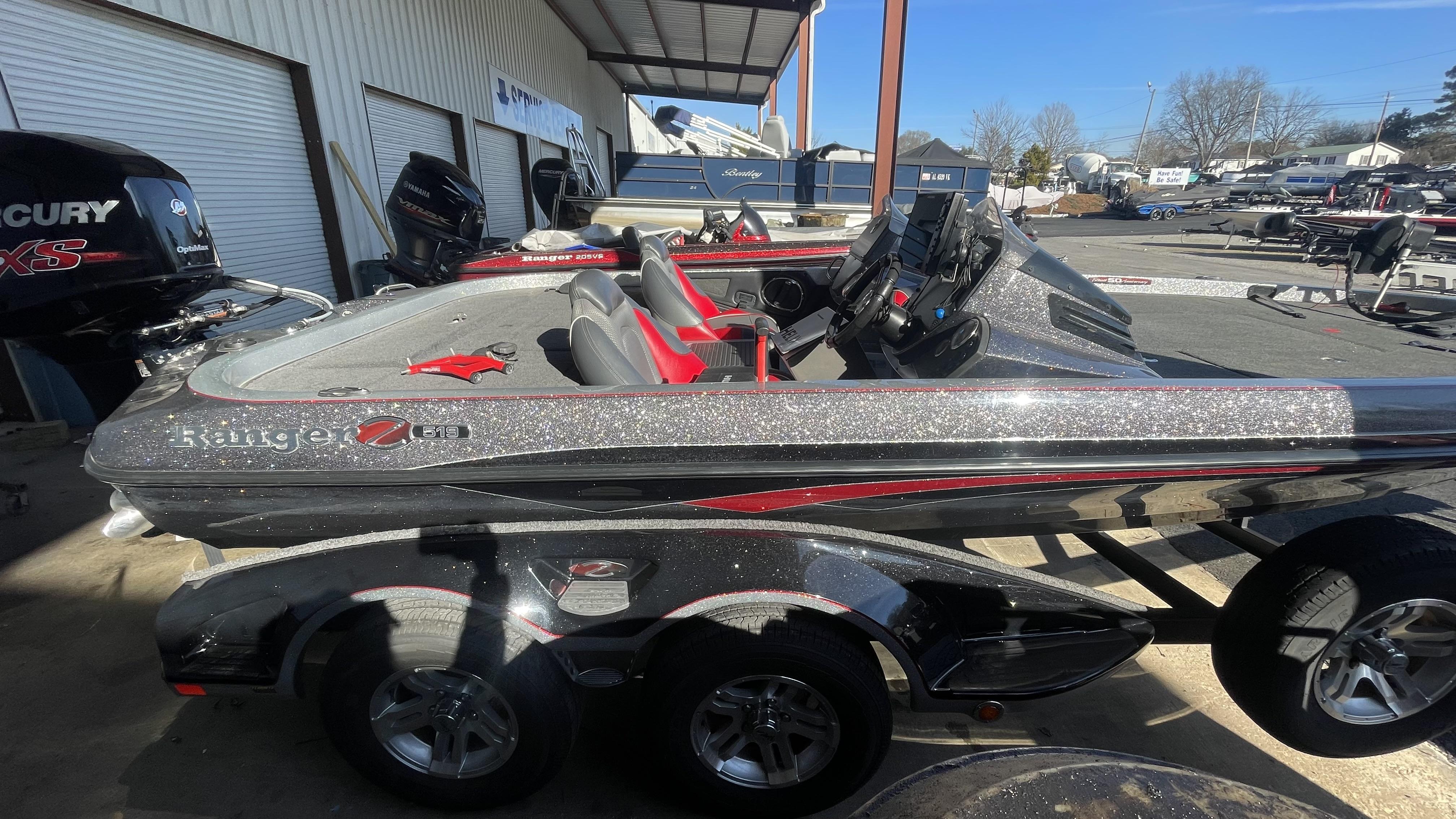 Slide: The Image of 2018 Ranger Z519C bass boat with Mercury engine, parked at a dealership. - 5