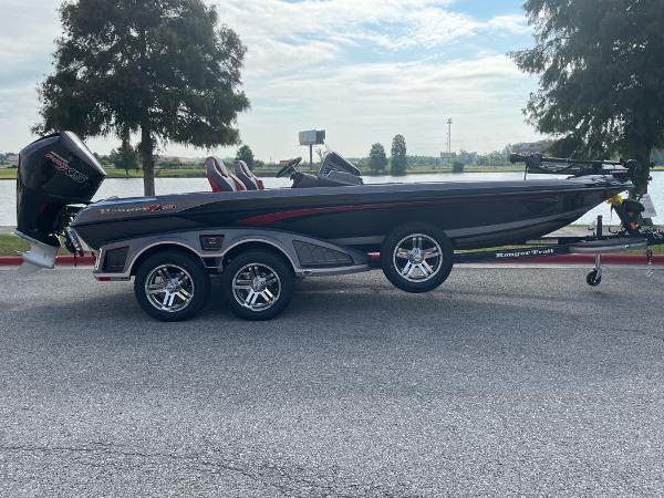 Slide: The Image of 2024 Ranger Z520R Ranger Cup Equipped boat on a trailer by a lake. - 1