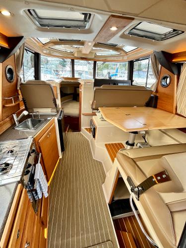 Slide: The Image of Luxurious 2019 Ranger Tugs R-29S interior with modern kitchen and dining area. - 1