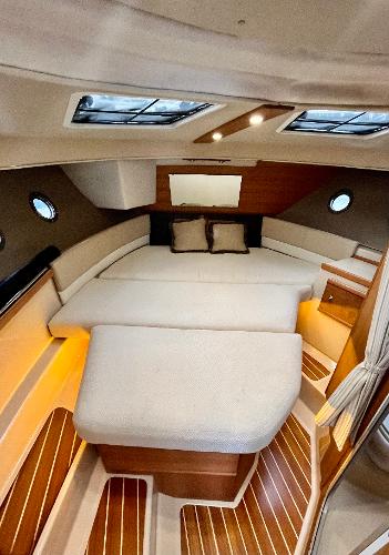 Slide: The Image of 2019 Ranger Tugs R-29S cabin interior with cozy bed and elegant wood finish. - 3