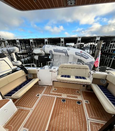 Slide: The Image of 2019 Ranger Tugs R-29S boat deck with seating, docked at marina. - 7